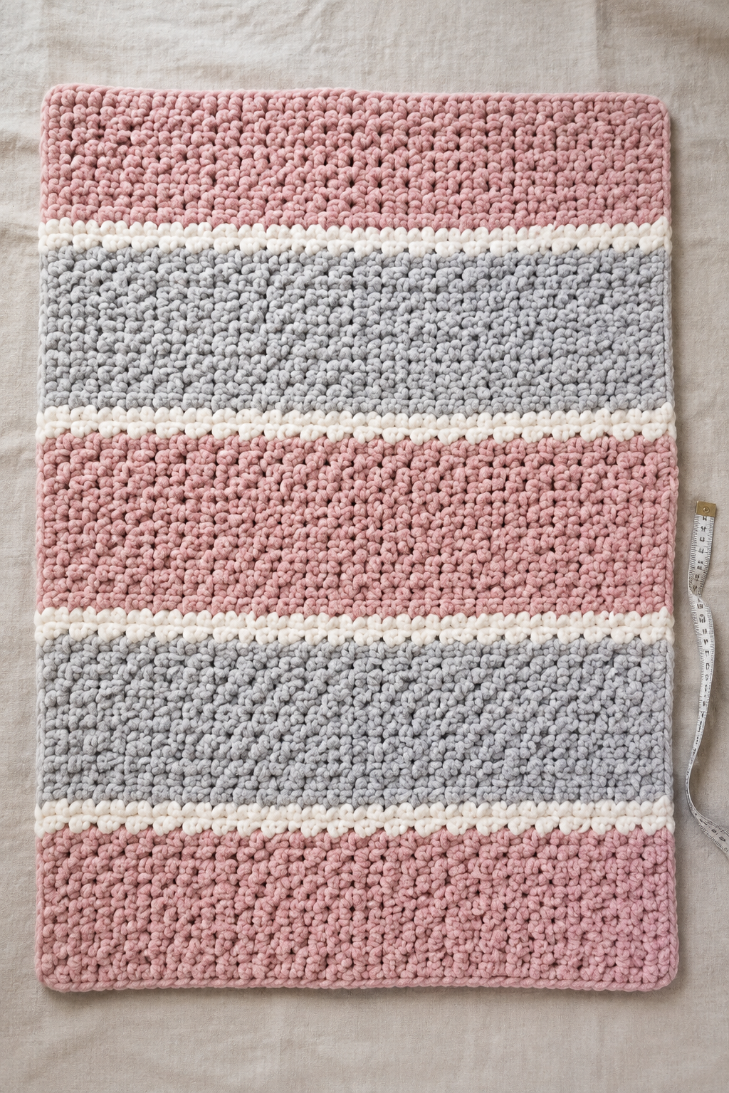 Pink gray and vanilla chunky baby blanket shown flat