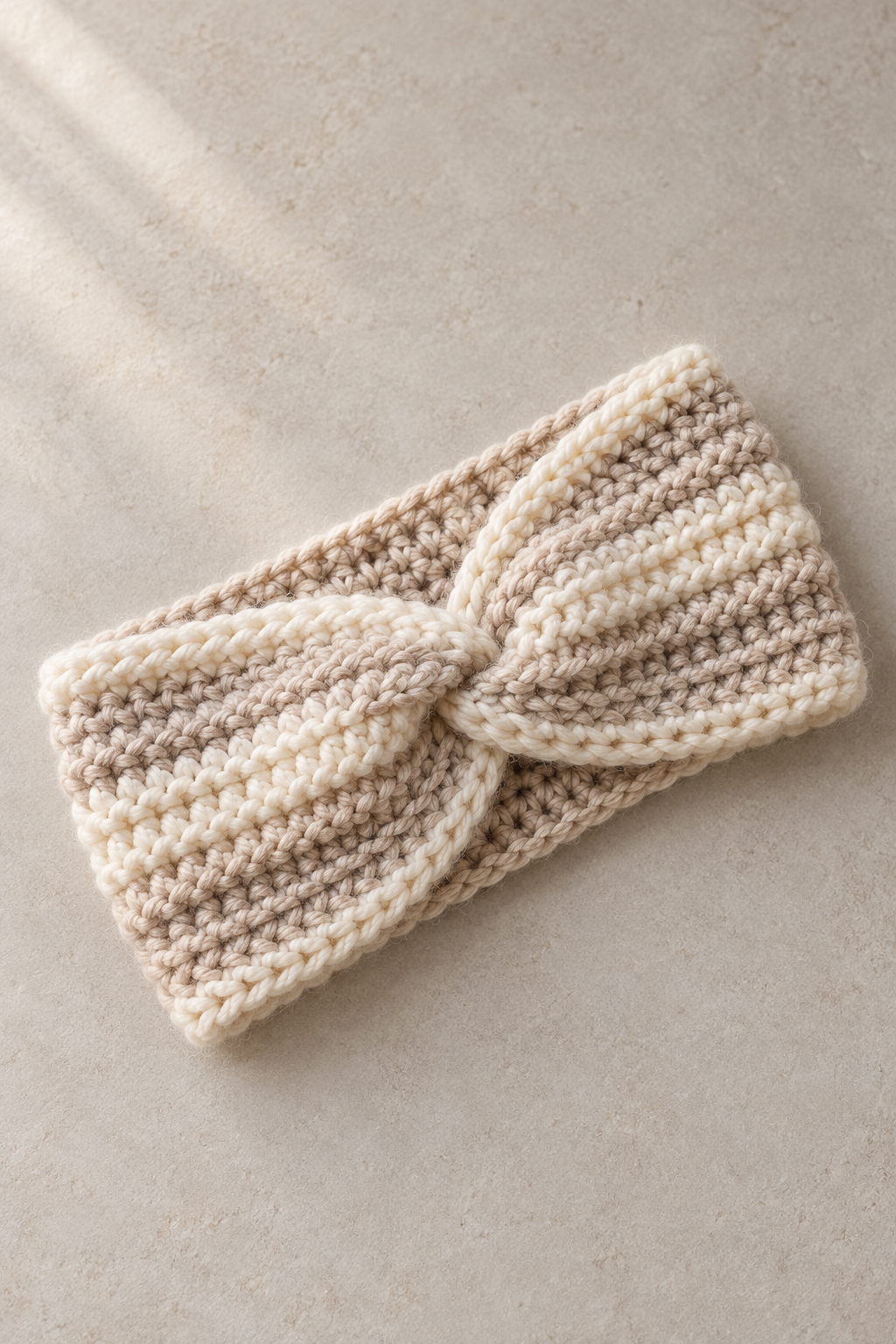 Finished crochet ear warmer showing its compact wearable shape