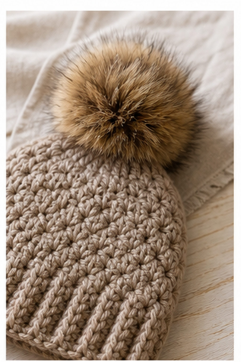 faux fur pom pom: finished pom-pom brushed round and sewn securely to a hat