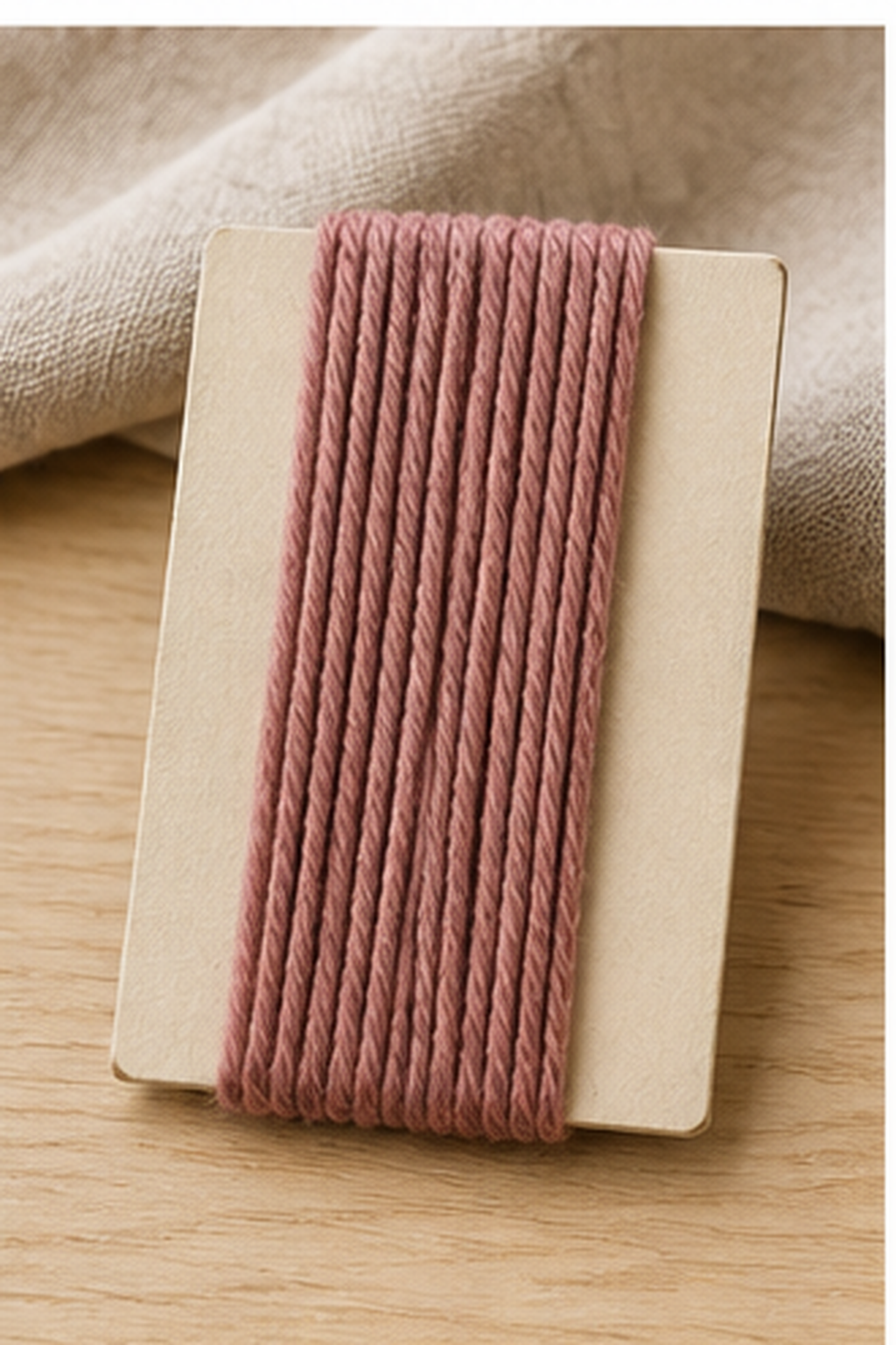 how to make a yarn tassel: even yarn wraps around a sturdy rectangular template