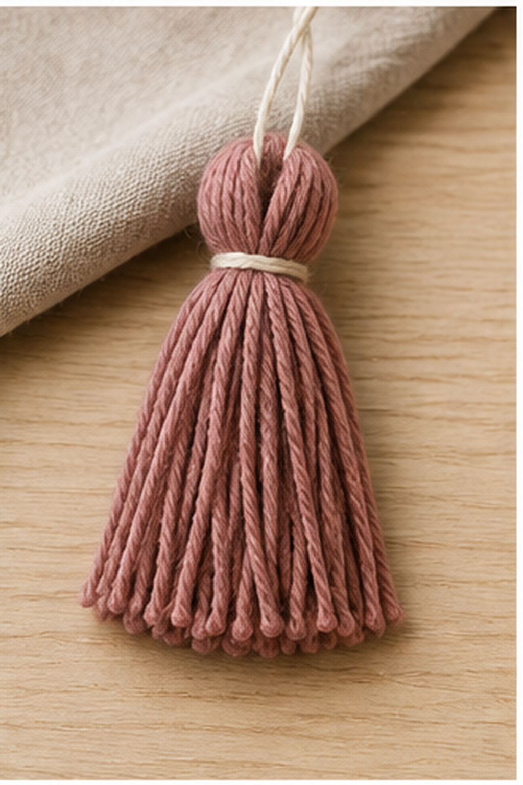 how to make a yarn tassel: neck wrap forming a tidy rounded tassel head