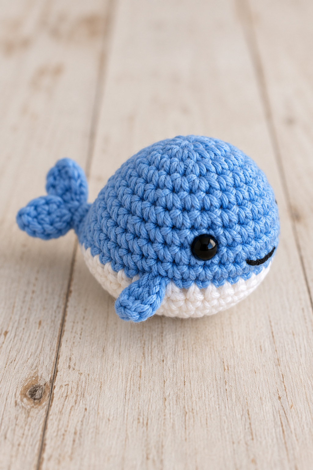 No sew tiny whale crochet pattern close view of a small rounded crochet whale