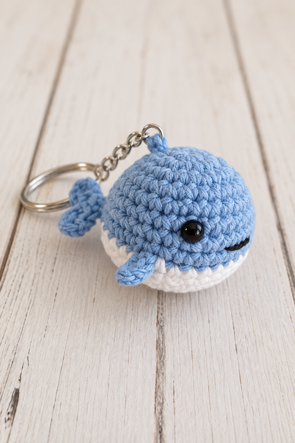 Finished tiny crochet whale with a subtle mouth