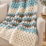 blue textured crochet blanket draped over a chair